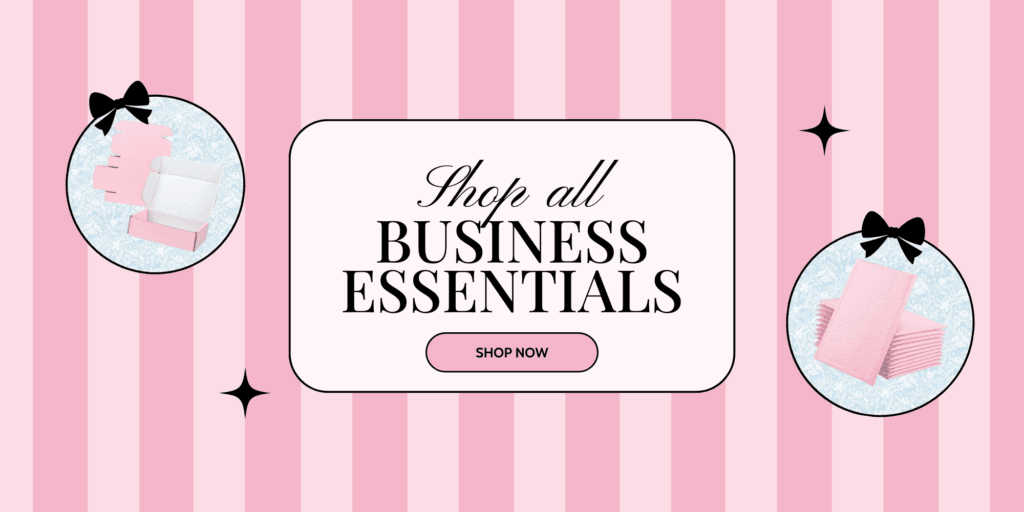 A pink and white striped background with the text Shop all BUSINESS ESSENTIALS in the center, flanked by images of pink boxes and tissue paper. There are black bows and sparkling effects as decoration.