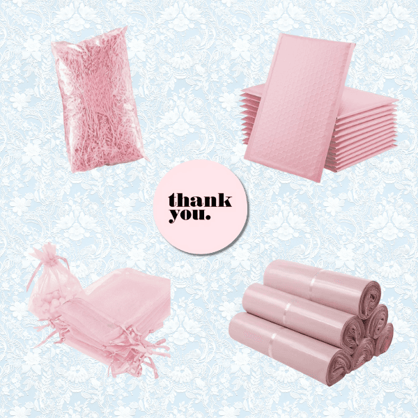 A flat lay of pink packaging materials including shredded paper, bubble mailers, organza bags, poly mailers, and a circular card in the center that says thank you. Background features a light blue floral pattern.